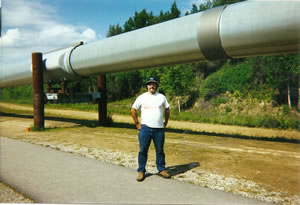 Ted in front of Alaska Pipe line a little north of Fairbanks, Alaska. 