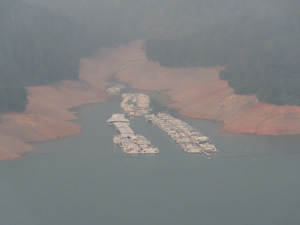View of houseboats on Lake Shasta through smoke filled sky, from entrance to Lake Shasta caverns. 