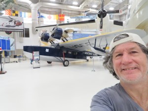 Ted with plane behind him in the Pensacola Naval Museum in Florida.