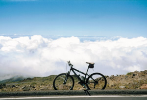 Photo of Ted’s rental bike further than previous photo down the mountian headed to the Pacifc Ocean in Maui, Hawaii.
