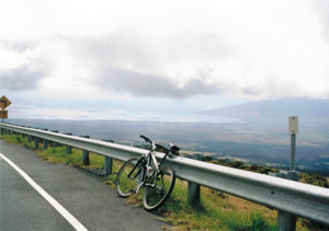 Photo of Ted’s rental bike further than previous photo down the mountian headed to the Pacifc Ocean in Maui, Hawaii.