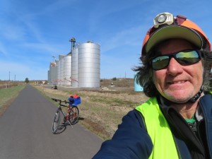 Ted and his bike in Cornwall, Idaho with grain silos near Butte Road.