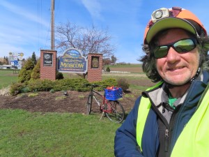 Ted and his bike with Welcome to Moscow, Idaho sign near cemetery.