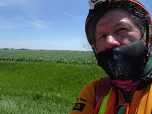 Ted on highway with typical farm behind him near Le Mars, Iowa.
