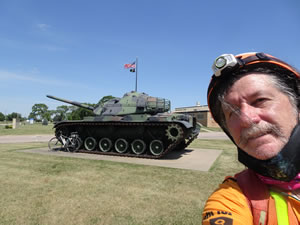 Ted with his bike near tank in Le Mars, Iowa.