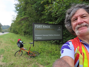 Ted and his bike at Ft. Knox sign near West Point, Kentucky.