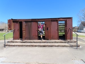 Ted at slave cage on display at Whitney Planation near New Orleans. (The cage was moved from a port where slaves were sold)