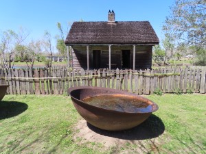 Slave quarters with large iron bowls used for boiling and refining sugar cane at the Whitney Plantation near New Orleans.