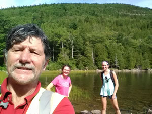 Ted with Natalie and Caleigh in the background at Bubble Pond in Arcadia National Park.