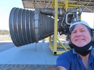 Ted with rocket engine behind him at NASA Stennis Visitor Center in Mississippi.