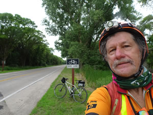 Ted with his bike near bike lane on road to Fremont State Lakes, Nebraska.