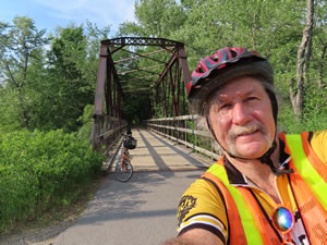 Bridge on Cheshire Rails Trail with Ted and his bike west of Keene, New Hampshire.