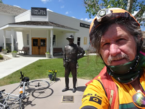 Ted with statue of Theodore Roosevelt behind him in Medora, North Dakota.