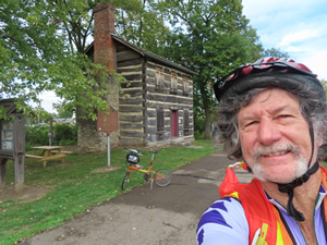 Ted and his bike with First Log Cabin Post Office in Franklin, Ohio.