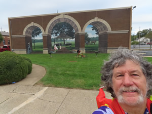 Ted in front of building with mural on building in Miamisburg, Ohio.