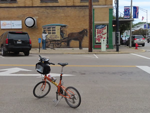Ted’s bike with mural on building in Miamisburg, Ohio in background.