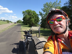 Ted with his bike on trial with Lewis and Clark expedition signs near Missouri River in Mobridge, South Dakota.