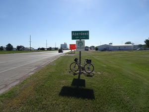 Ted’s bike near the sign enter Aberdeen, South Dakota.