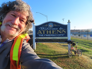 Ted and his bike at the welcome sign in Athens, Tennessee.