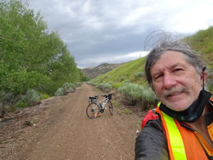 Ted with his bike on rails to trail next to Echo Dam road that following the east shore of Echo Reservoir near Echo, Utah.