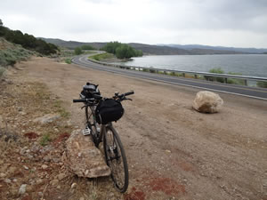 Ted with his bike on rails to trail next to Echo Dam road that following the east shore of Echo Reservoir near Echo, Utah.