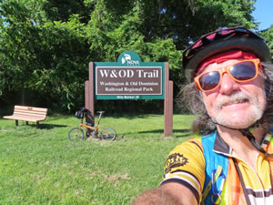 Ted with his bike at W&OD trail sign in Virginia.