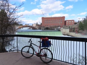 Ted’s bike with Spokane Falls in background near Riverfront park in Spokane.