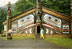 Ted in front of tribal house at Totem Bright Park near Ketchikan, Alaska.