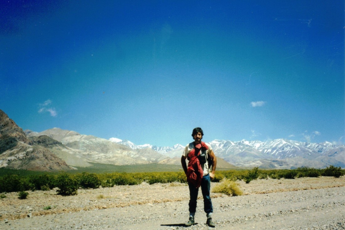 Ted on the road that follows mountains that are about 20,000 feet high. Ted is standing on the back highway to San Juan.