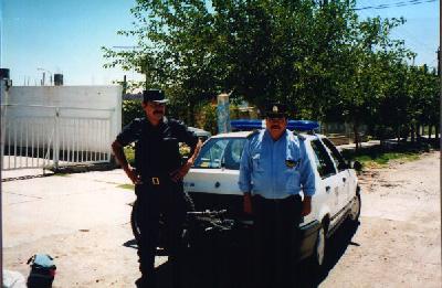 The police officers that gave Ted a ride from downtown San Juan to the Rodreguez's house. Notice Ted's bike is in the back of the police car.