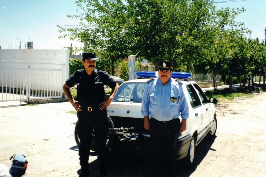 The police officers that gave Ted a ride from downtown San Juan to the Rodreguez's house. Notice Ted's bike is in the back of the police car.