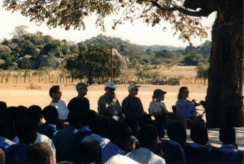 Our bike group watching the children's skits at the secondary school on Kumalo land.  Left to right - Gary, Ezra, John, Karen, Heather and Becky.
