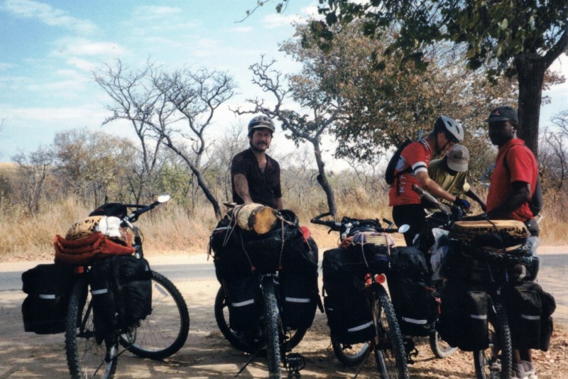 Our bikes loaded with camping gear and African souvenirs in front of the craft center near the turn off to Rhodes grave.  Bikes left to right John’s, Ted, Becky’s and Shingi’s.  People left to right - Ted, Ezra, person looking at Ezra’s GPS unit and Shingi.