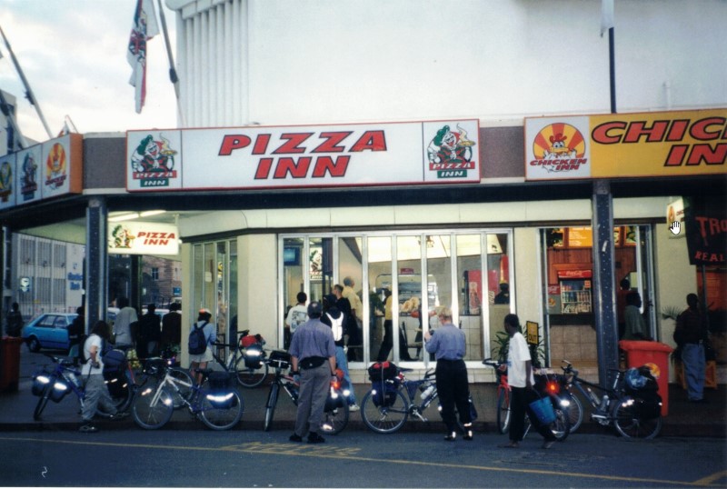 Our bike group waiting for pizza in front of the Pizza Inn in Bulawayo.