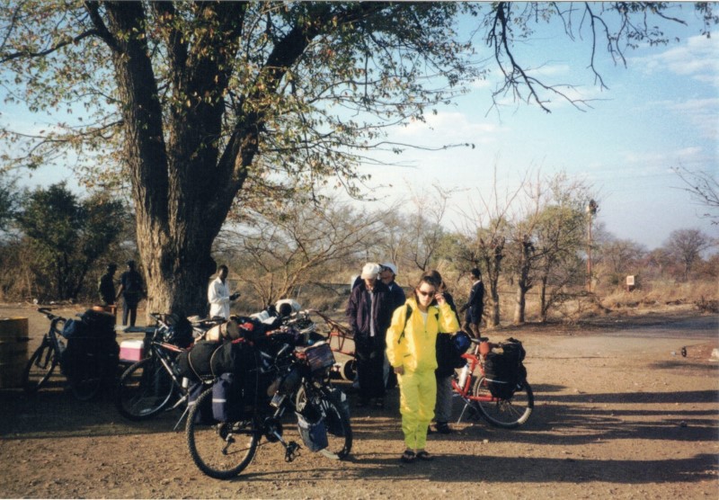 My bike next to Becky in the parking lot to Victoria Falls.  Becky is wearing her bright yellow rain suit for the mist coming off the falls.  It was not very wet.