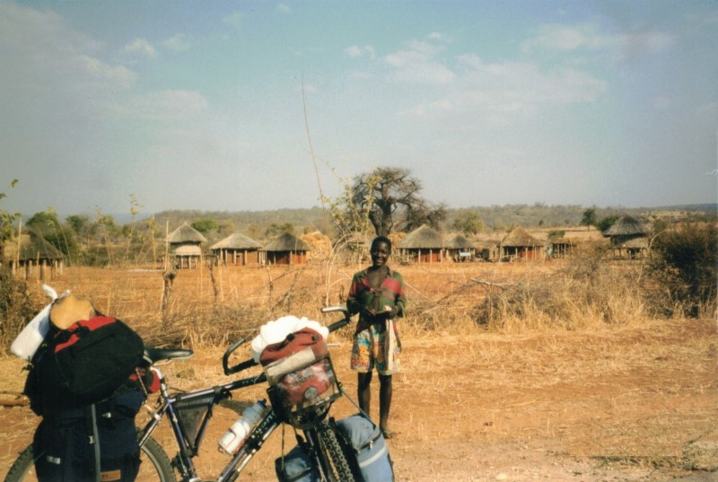 Teds bike loaded with gear between Dete and Sianzyundu.  Ted gave this boy a postcard and US quarter.