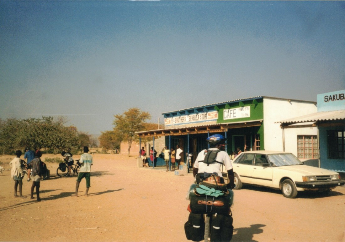 Shingi cycling to a strip mall store between Sianzyundu and Binga.