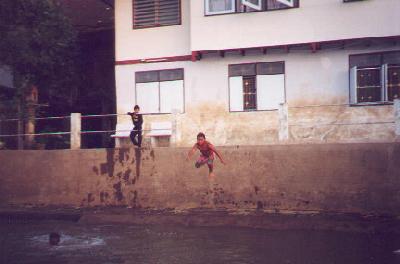 A child jumping into the river as seen from the river ride around Ayuthaya, Thailand.