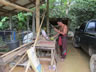 Man preparing coconut for me at his home.