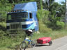 This truck has probably been on the side of the road for a long time in El Salvador, weeds are starting to cover the truck.