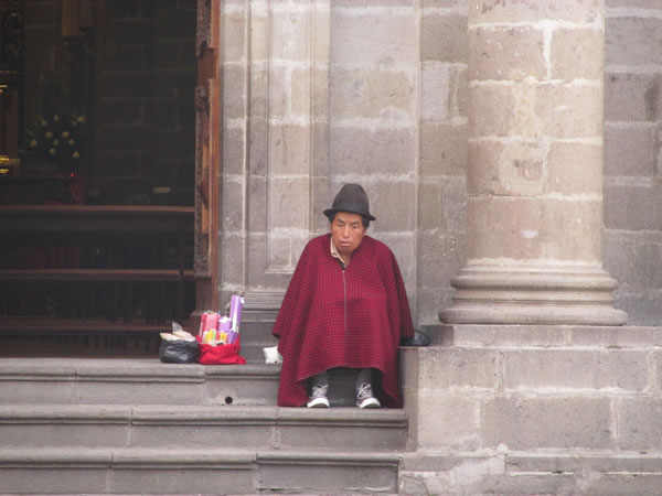 Man on church stairs at Riobamba, Ecuador.