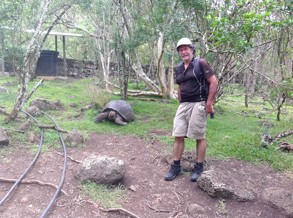 Ted with Tortes behind him on Isle Santa Maria, Ecuador.