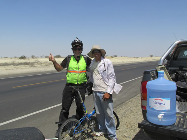 Highway worker with Ted, after he gave Ted water in desert between Piura, Peru and Chiclayo, Peru.