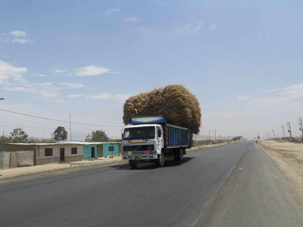 Loaded down truck on highway between Chiclayo, Peru and Pacasmayo, Peru.