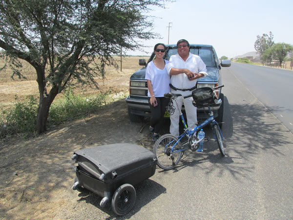 A man with his daughter next to highway between Chiclayo, Peru and Pacasmayo, Peru.