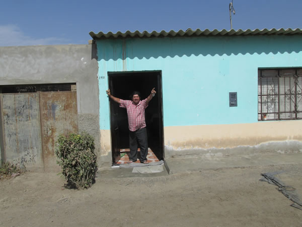 A friendly man at his front door between Chiclayo, Peru and Pacasmayo, Peru.