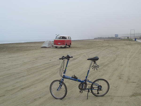 Ted’s bike with a VW truck in the background camping on the beach of Huanchaco, Peru.