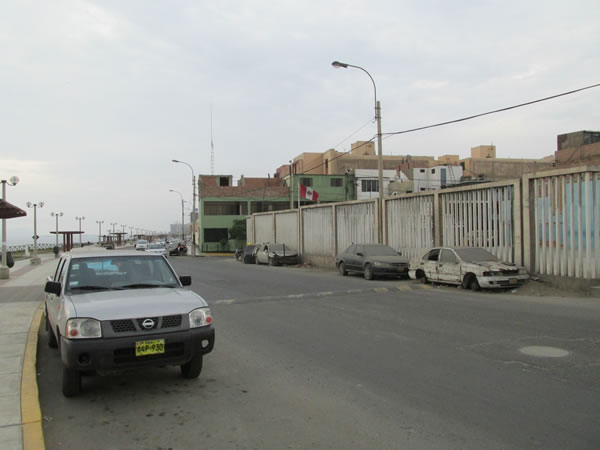 Stripped down cars near road in Lima, Peru.