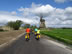 Netherlands – Nancy and Nancy in front of Ted about to pass another windmill.