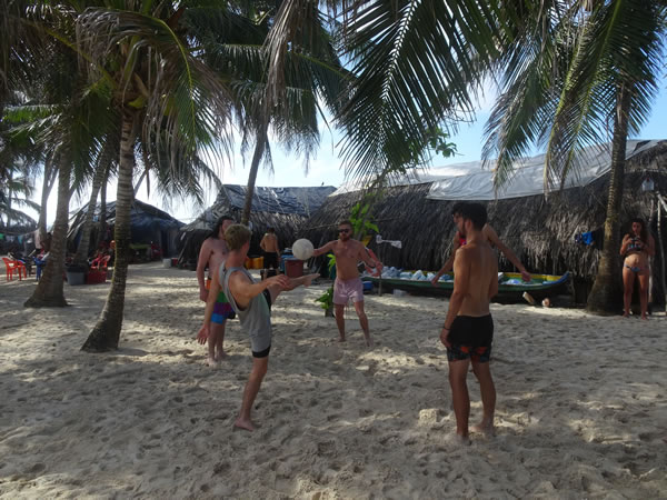 San Blas adventure people playing kick ball on first nights of San Blas island, Panama.